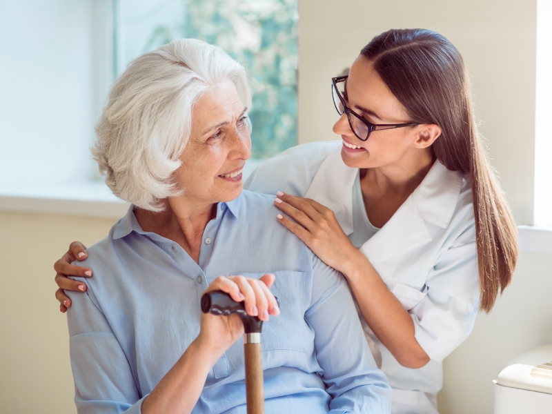 Young woman helping senior
