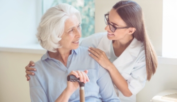 Young woman helping senior