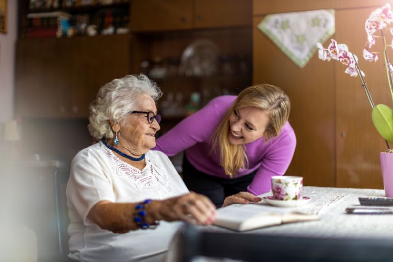 Young woman spending time with an elderly woman at home