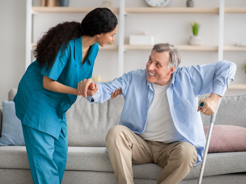 elderly man with cane sitting on couch