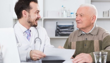 Elderly man talking with doctor