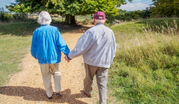 elderly couple walking on a path