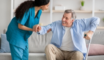 elderly man with cane sitting on couch